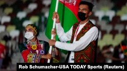 Afghan athletes take part in the opening ceremony for the Tokyo Olympics in 2021.