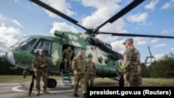 Ukrainian President Petro Poroshenko leaves a helicopter as he arrives for a test of U.S. antitank missile systems on May 22, 2018.