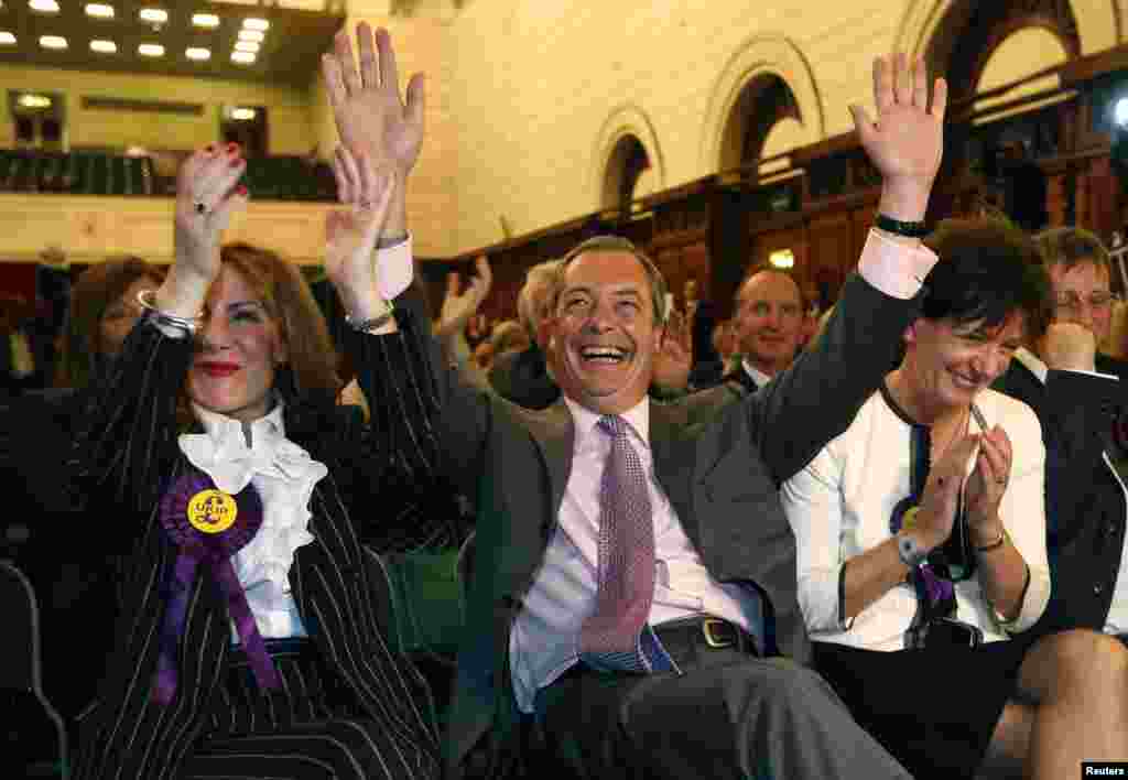 Nigel Farage (center), the leader of the right-wing United Kingdom Independence Party (UKIP), celebrates with his party's candidates after winning some 28 percent of the vote in Great Britain.
