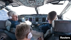 Sukhoi's chief civil test pilot, Aleksandr Yablontsev (left), and his crew sit in the cockpit of a Sukhoi Superjet during a flight on May 8, one day before the deadly crash in Indonesia.