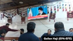 Customers at an Iraqi tea house watch the news on TV after Iran launched a number of missiles at bases in Iraq hosting U.S.-led coalition troops, in Irbil on January 8.