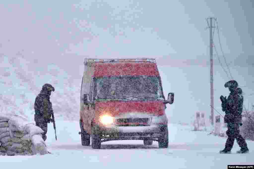Russian peacekeepers man a checkpoint on the outskirts of Stepanakert on November 29. After six weeks of fighting between ethnic Armenian forces and Azerbaijan's military, a Moscow-brokered truce was signed on November 9 that brought some 2,000 Russian soldiers to Nagorno-Karabakh.