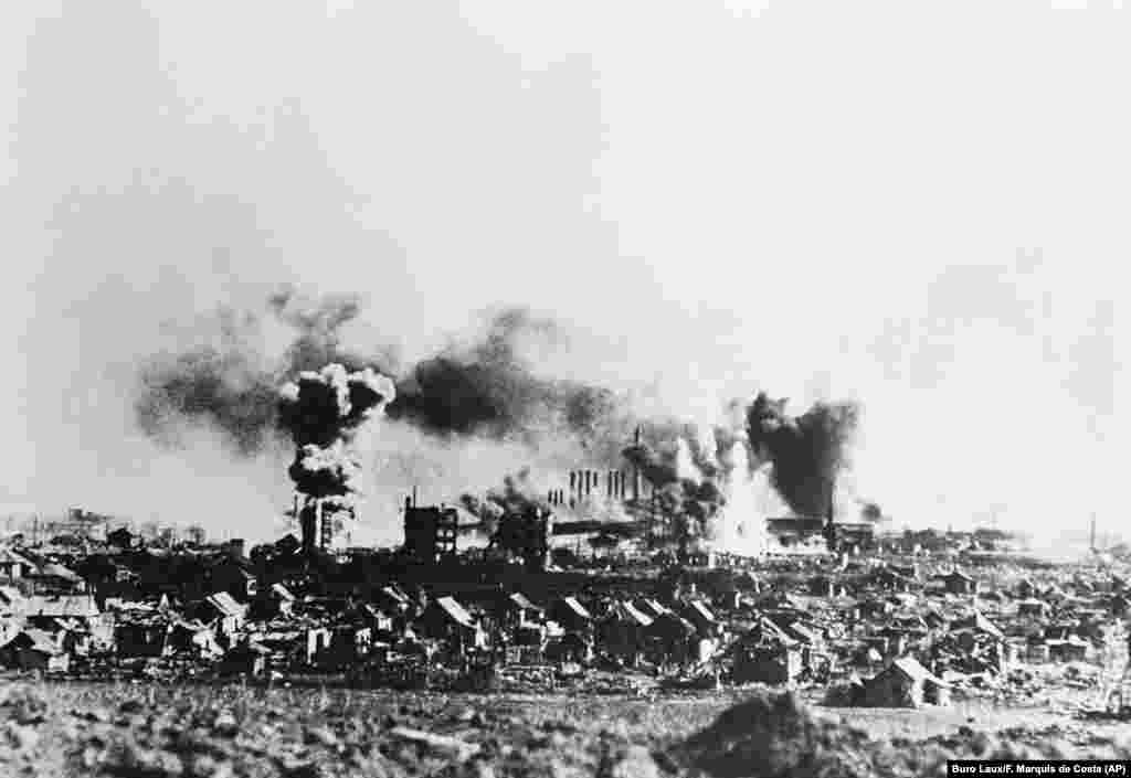 Smoke billows from an industrial area of Stalingrad following an attack by German Stuka dive bombers on November 24, 1942, according to a caption passed through German government censors. (Buro Laux/F. Marquis de Costa via AP)