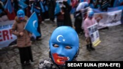 Uyghur protesters who have not heard from their families living in Xinjiang hold placards and Uyghur flags during a protest against China in Istanbul last month.