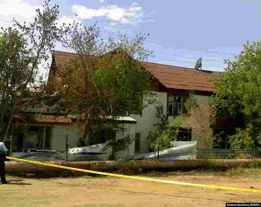 A police cordon in front of a slightly damaged home across the street in Astana from the blast on May 24.