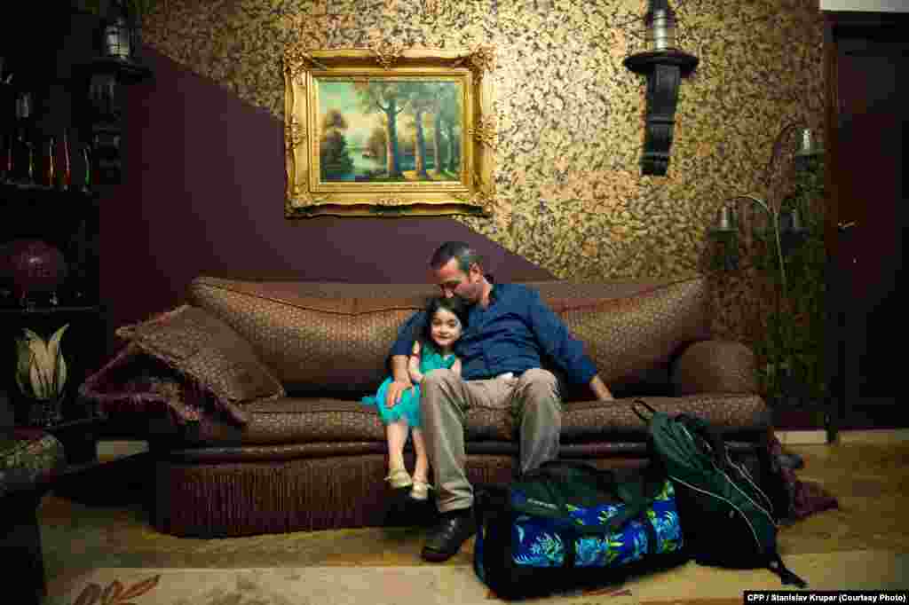 First Prize, General News: Anas Abduldayem, a Syrian, sits with his daughter on the day he left his family in Cairo in an attempt to emigrate to Italy by boat. (Stanislav Krupar)