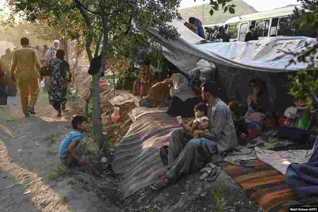 Internally displaced Afghans sit under their shelters at the Sara-e Shamali camp in Kabul.&nbsp;