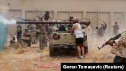 A fighter loyal to Libya's UN-backed government fires toward the forces loyal to Khalifa Haftar on the outskirts of Tripoli. (file photo)