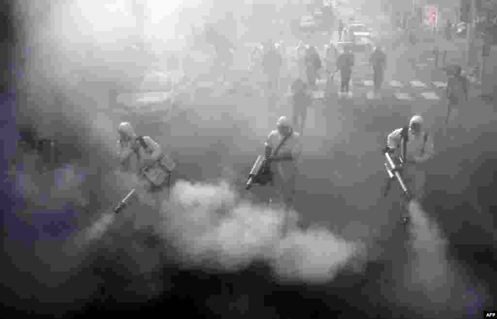 Iranian firefighters disinfect streets in the capital, Tehran, in a bid to halt the wild spread of coronavirus.