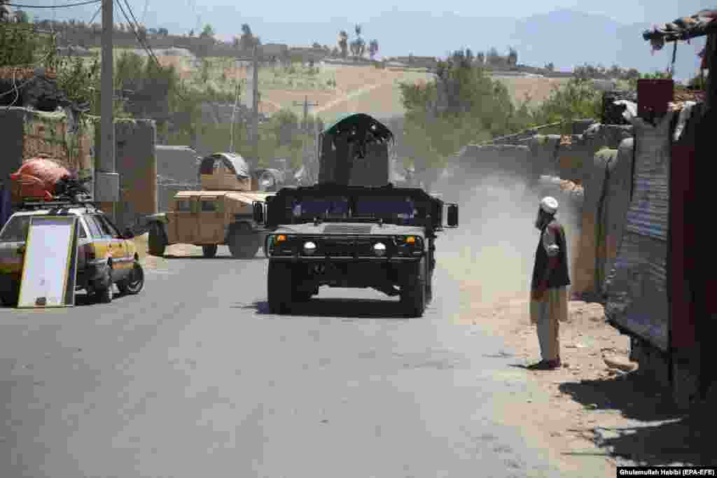 Afghan security forces patrol the Alishang district of Laghman Province after reportedly clearing the area of Taliban fighters on July 8. 