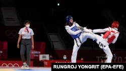 Kimia Alizadeh (left) in action during her first-round victory over compatriot Nahid Kiyani in the taekwondo women's under-57-kilogram competition at the Tokyo Olympics. She eventually made it to the semifinal stage, just missing out on emulating her bronze-medal finish at the 2016 games when she became the first Iranian woman to win an Olympic medal.