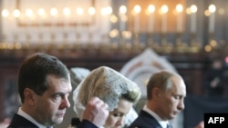 President Dmitry Medvedev (left) and Prime Minister Putin at the enthronememnt of the new Russian Orthodox patriarch on February 1