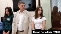 Maria (left) and Angelina Khachaturyan attend a court hearing in Moscow in June 2019.