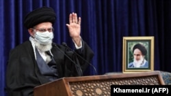 Iranian Supreme Leader Ayatollah Ali Khamenei waves as he addresses people from East Azerbaijan Province by video conference in Tehran on February 17.