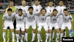 The Uzbek national soccer team poses for a group photograph during the 2011 Asian Cup.