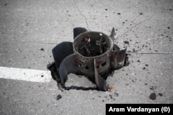 The tail fins of a large rocket that was embedded in a road in Stepanakert