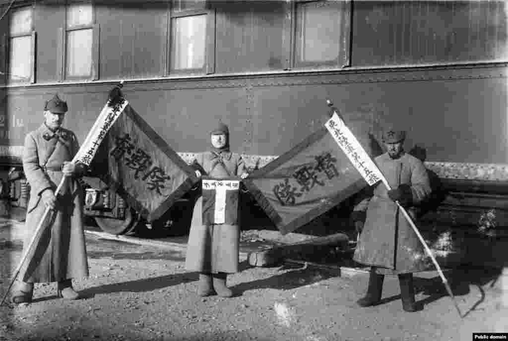 Russian communist fighters with captured Chinese flags during the 1929 Sino-Soviet conflict. The third problem with the hat was ideological: The Russian nationalism evoked by the budyonovka's shape didn’t fit with the Bolsheviks' global ambitions to unite workers of the world in a communist revolution. 