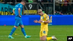 Ukraine's Mykhailo Mudryk (right) celebrates at the end of his country's victorious Euro 2024 playoff against Greece on March 26.
