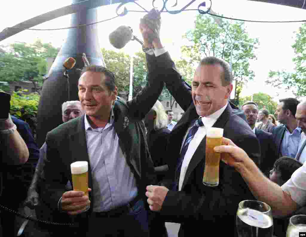 The head of the far-right Freedom Party of Austria, Heinz-Christian Strache (left), and fellow candidate Harald Vilimsky celebrate the preliminary results, which showed their party with some 20 percent of Austria's vote.