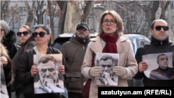 Armenia - Politician Mane Tandilian (second from right) and other protesters hold pictures of Ruben Vardanyan, Yerevan, February 28, 2025.