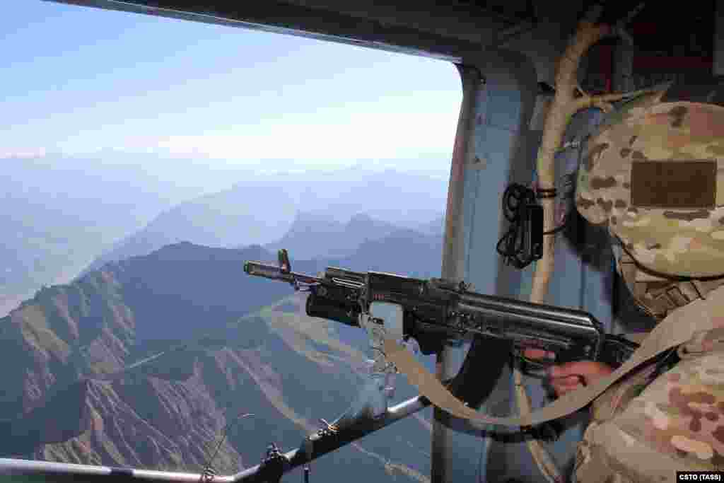 A serviceman from the Russian-led Collective Security Treaty Organization looks over the border area between Tajikistan and Afghanistan on July 5. Tajikistan has seen a surge of refugees fleeing across the border amid the recent Taliban advances. 