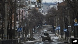 Ukrainian soldiers ride in a Humvee in Bakhmut in Ukraine's Donetsk region on December 21.