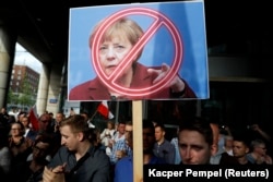 Supporters of the far-right National-Radical Camp (ONR) protest against EU plans to start legal action against Poland over judiciary reform, in front of the European Commission Representation office in Warsaw in July 2017.