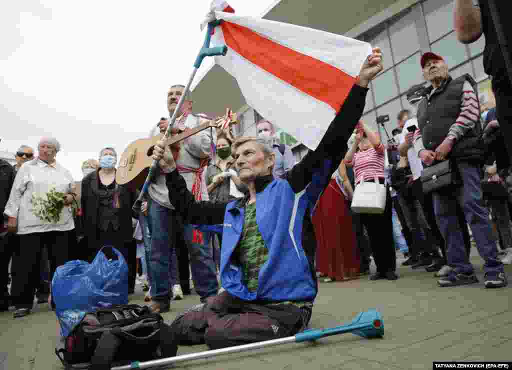 A rally attendee holds a white-red-white flag, which is used by opposition supporters, during the June 7 rally. 