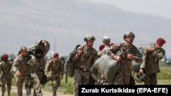 GEORGIA - Georgian and U,S, servicemen gather after parachuted exercises at the multinational military exercise 'Agile Spirit 2021' at a military base outside Tbilisi, August 1, 2021.