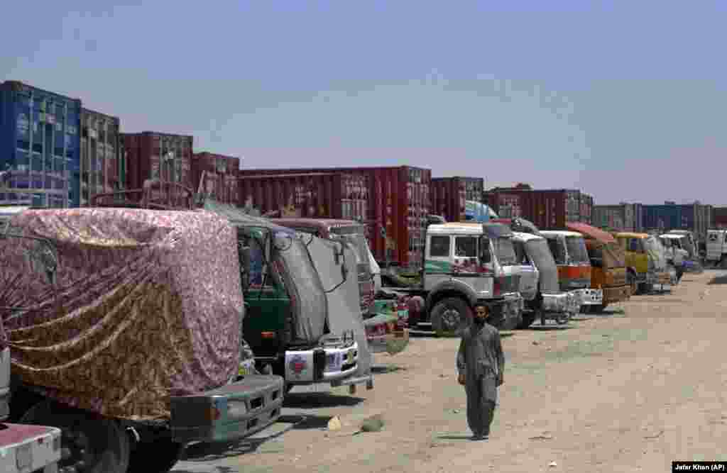 A driver walks past Afghan-bound trucks stuck at the Chaman border crossing.