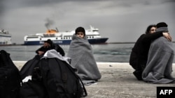Children wrapped in blankets stand in a harbor as migrants and refugees arrive on the Greek island of Lesbos while crossing the Aegean Sea from Turkey earlier this month. Hundreds if thousands of migrants have made a similar journey from Turkey, which is struggling to host 2.7 million registered refugees from Syria, plus an unknown number of unregistered refugees. (file photo)