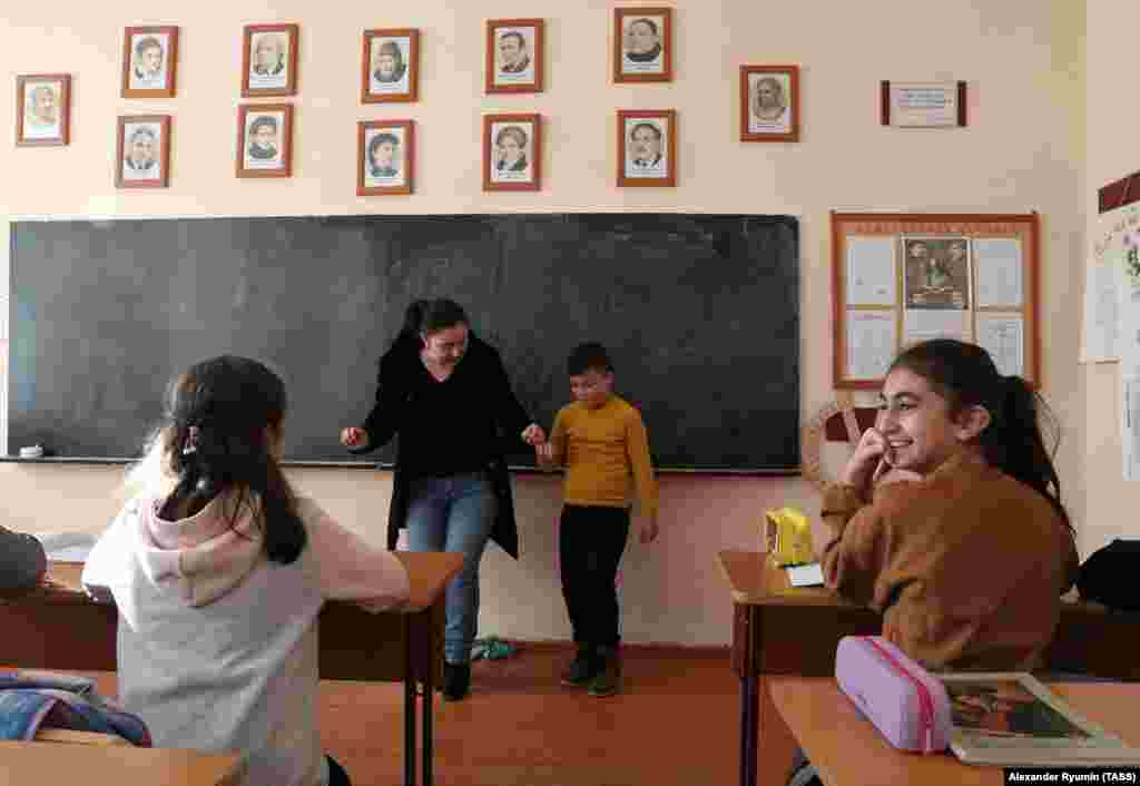 A boy being taught a traditional Armenian dance in a Stepanakert school on December 2. Ahead of the cease-fire agreement, Azerbaijan's military overwhelmed ethnic Armenian separatist forces and threatened to advance on Stepanakert.