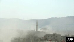 Smoke rises following what Syrian rebels claim to be a toxic-gas attack by pro-government forces on the outskirts of Damascus on August 21.