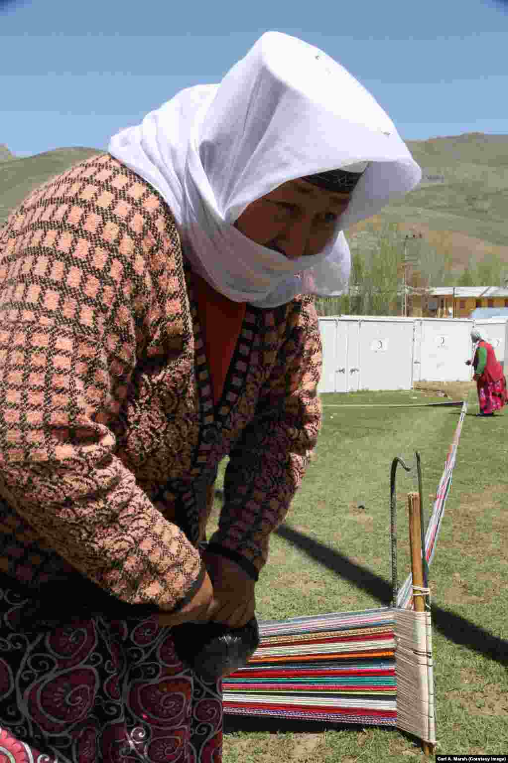 A woman weaves a carpet in Uluu Pamir. Carpets woven here are sold to traders in the city of Van.