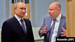 The firms targeted include a company owned by Russian billionaire Vladimir Potanin, pictured here with Russian President Vladimir Putin (left).
