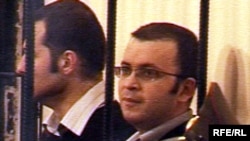 Youth activists Emin Milli and Adnan Hajizada behind bars during their trial in October