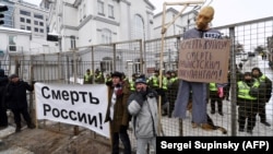 A mannequin depicting Russian President Vladimir Putin is hung on a gallows with a sign reading "Death to Putin, death to the rascist occupier" during a rally outside the Russian Consulate in Kyiv on March 18.