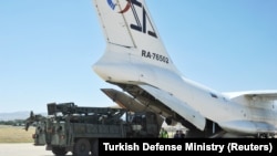 Parts of a Russian S-400 defense system are unloaded from a Russian plane at Murted Airport near Ankara in August.
