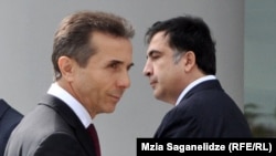 Outgoing Georgian President Mikheil Saakashvili (right) and Prime Minister Bidzina Ivanishvili (file photo)