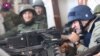Російський актор Михайло Пореченков стріляє із великокаліберного кулемета по українських силах, які утримували Донецький аеропорт. 30 жовтня 2014 року. (кадр із відео)