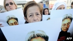 Human rights activists at a rally in honor of slain Russian journalist Anna Politkovskaya in Moscow in 2010.
