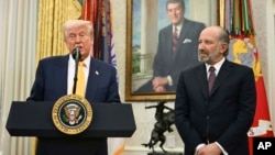 U.S. President Donald Trump (left) and Commerce Secretary Howard Lutnick (R) at Lutnick's swearing-in ceremony on February 21.