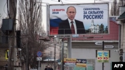 A campaign billboard for Russian President Vladimir Putin in the annexed Ukrainian peninsula of Crimea earlier this year. 