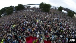 Roses lie on a balcony overlooking a vigil in Oslo attended by some 150,000 people holding flowers in a show of solidarity with the victims of recent attacks in Norway on July 25.