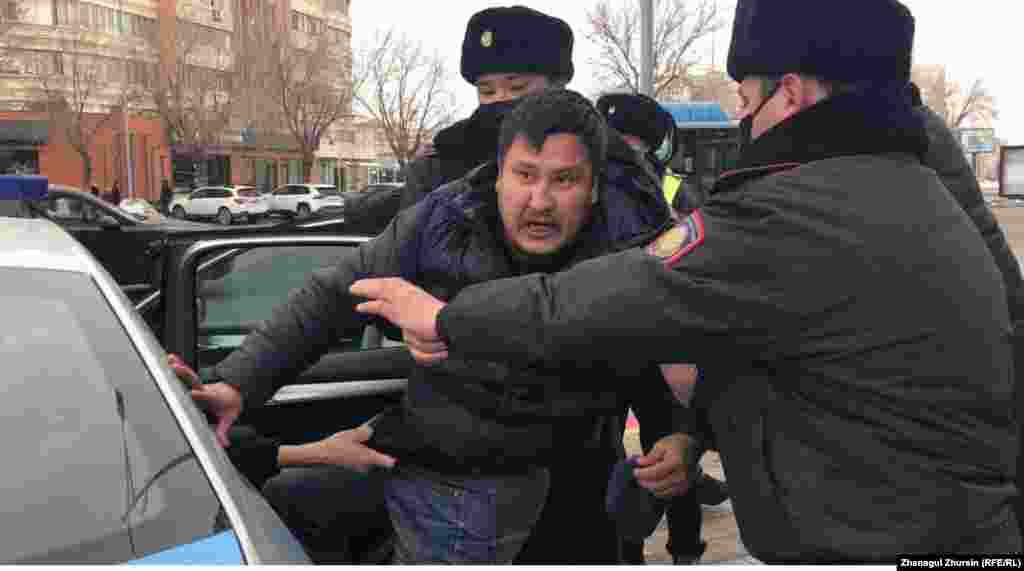 Police detain protesters in the western city of Aqtobe.