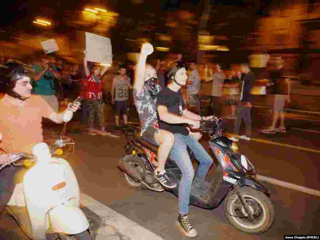 A group of young protesters on scooters during the short march. 