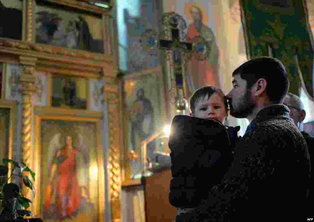 People attend a service at a Russian Orthodox church in Comrat.