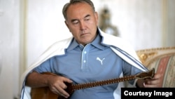 Kazakh President Nursultan Nazarbaev playing the dombra, a national instrument of Kazakhstan.