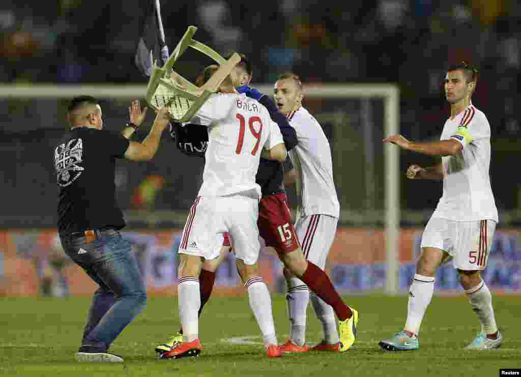 ...with some team officials and fans breaking through security and managing to approach and attack Albanian players.