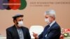 Afghan Economy Minister Abdul Hadi Arghandiwal and Finnish Foreign Minister Pekka Haavisto speak prior to the plenary session of the 2020 Afghanistan Conference at the United Nations in Geneva on November 24.